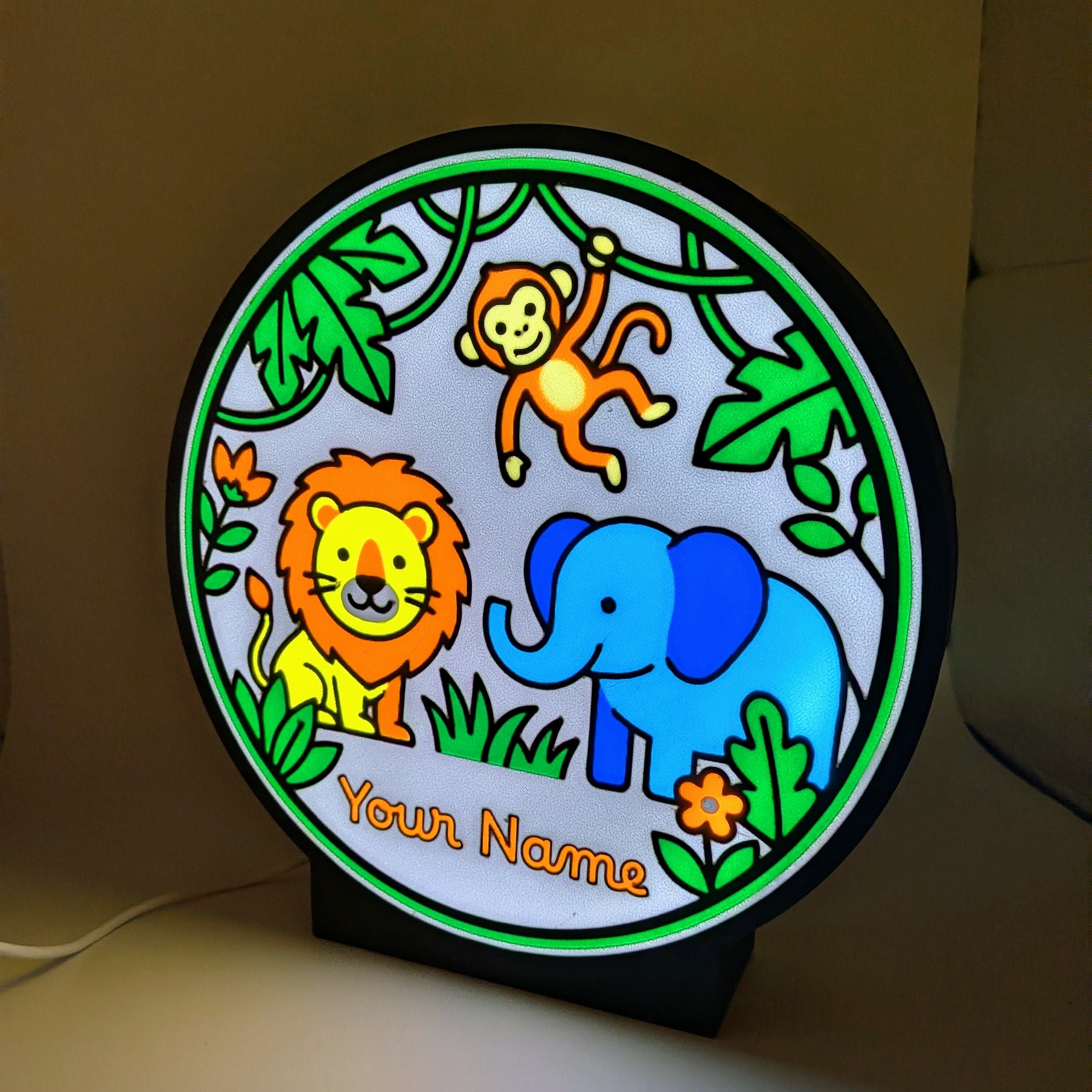 Lampada LED rotonda con cornice verde, scimmia, leone ed elefante