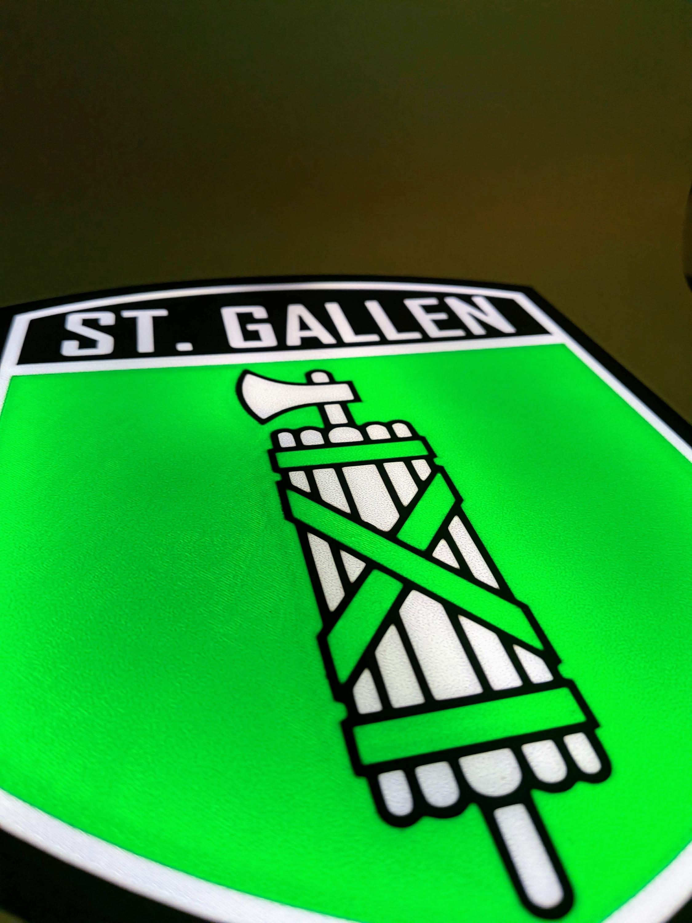 Close-up of St. Gallen crest design on green LED lightbox shield