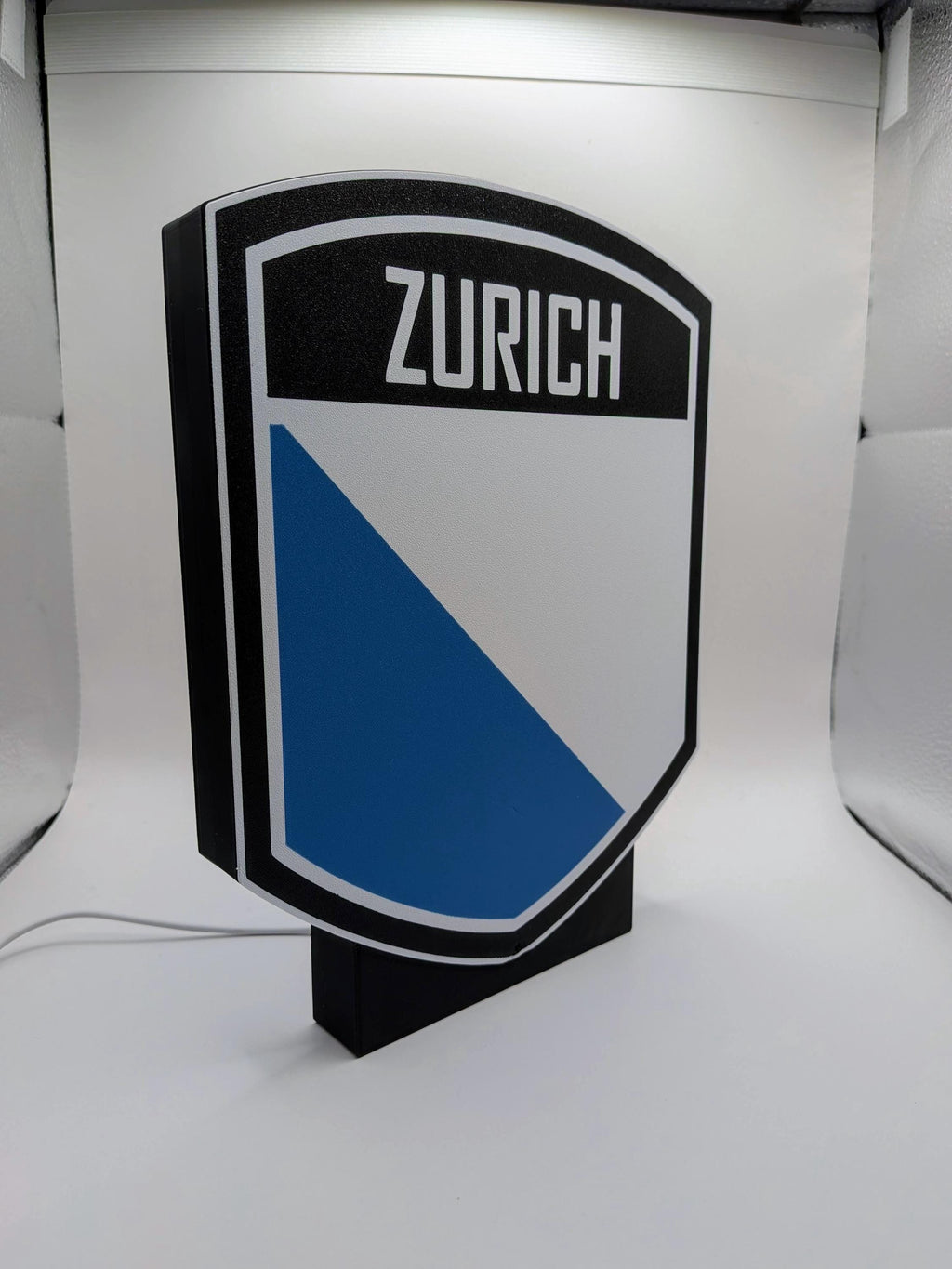 Lampada LED lightbox scudo ZURICH con pannello bianco e triangolo blu