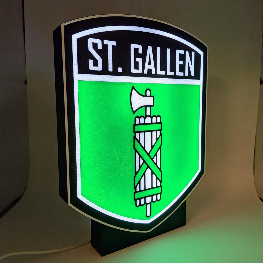 Lampada LED lightbox con stemma ST. Gallen su sfondo verde e base nera accesa
