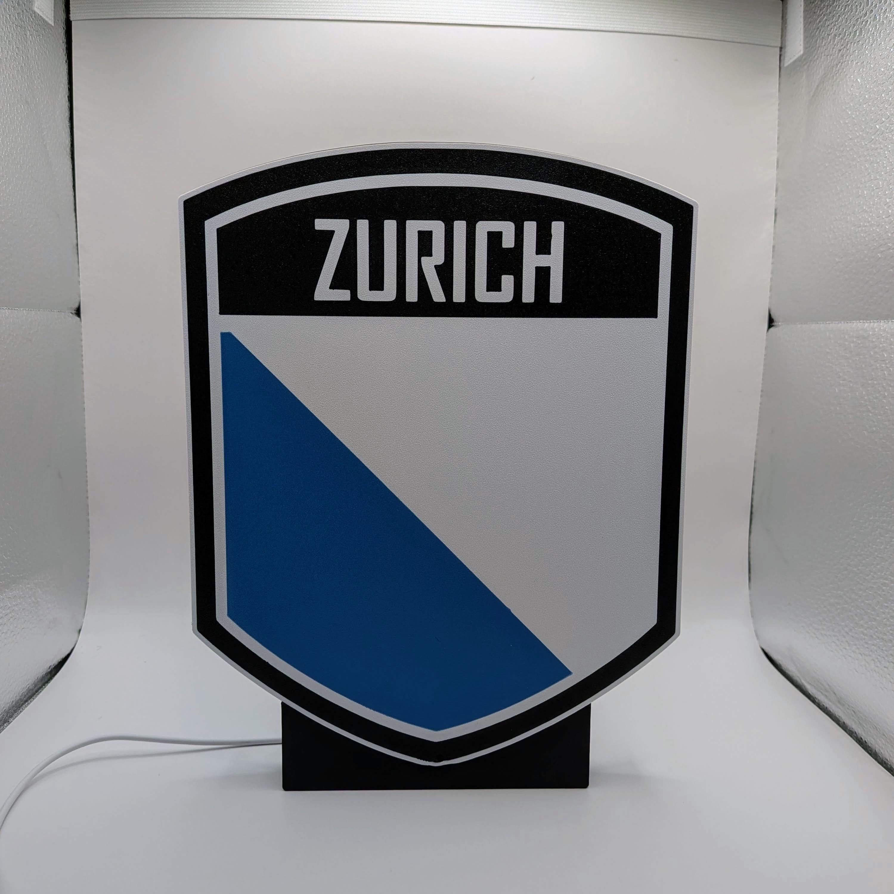 Lampada LED lightbox scudo ZURICH con pannello bianco e triangolo blu scuro