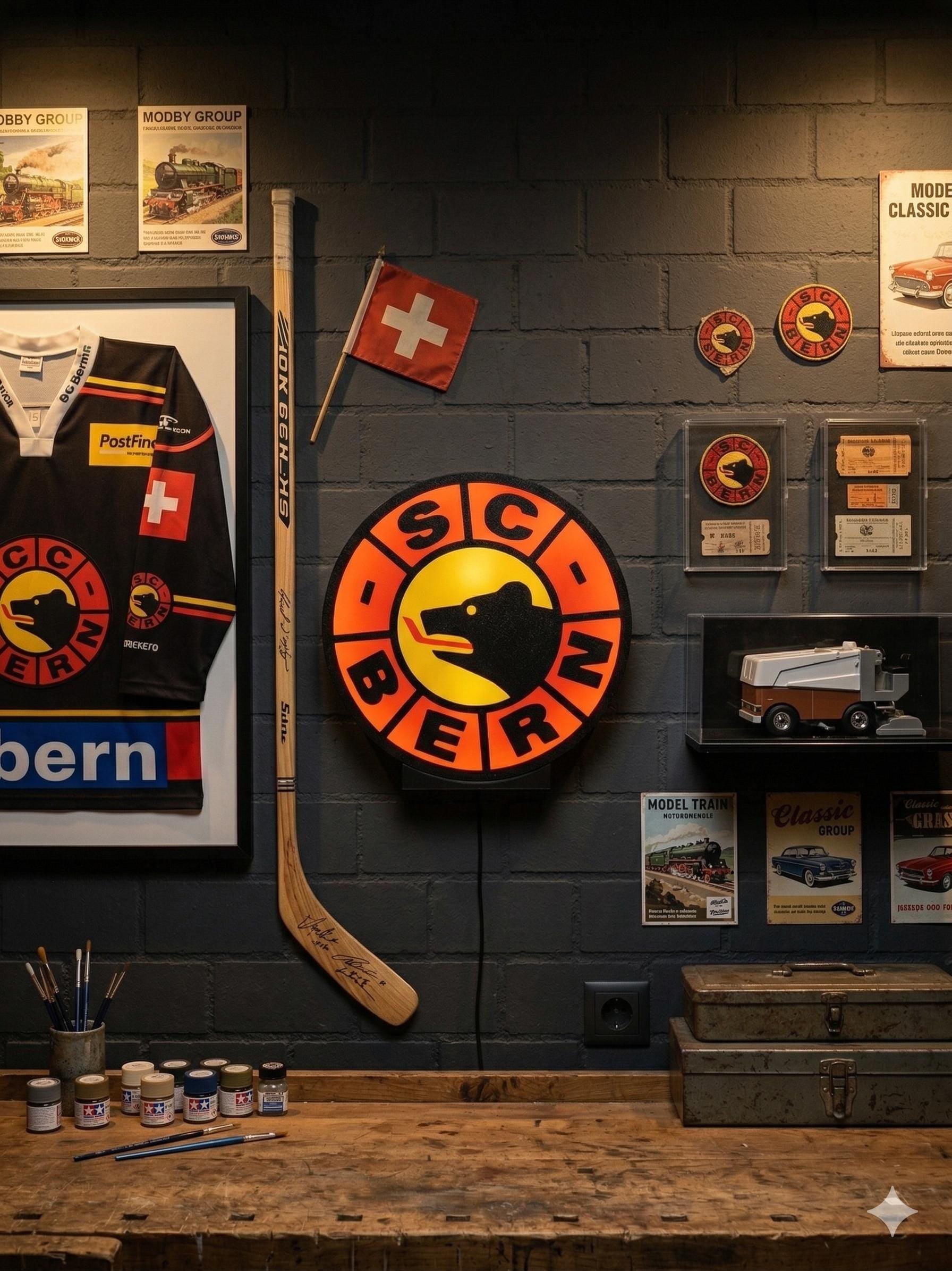 Lampada LED rotonda SC Bern su supporto nero, logo arancione e cerchio giallo.